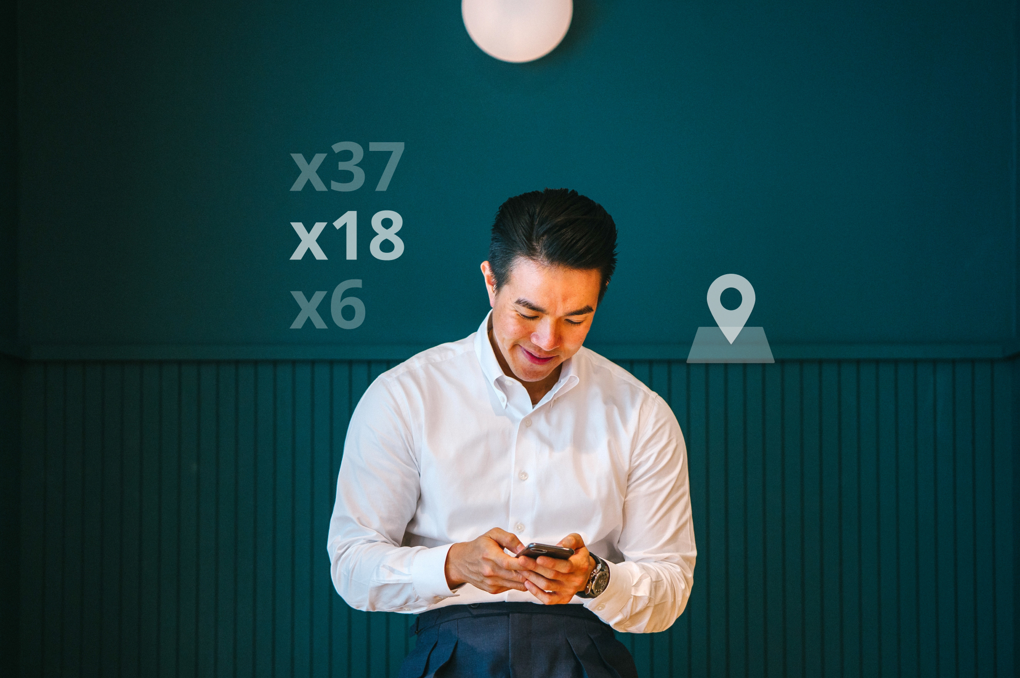 A smiling manager checking his inventory on his mobile phone